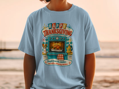 Light blue t-shirt with "Happy Thanksgiving" text, oven with turkey, and kitchen items.