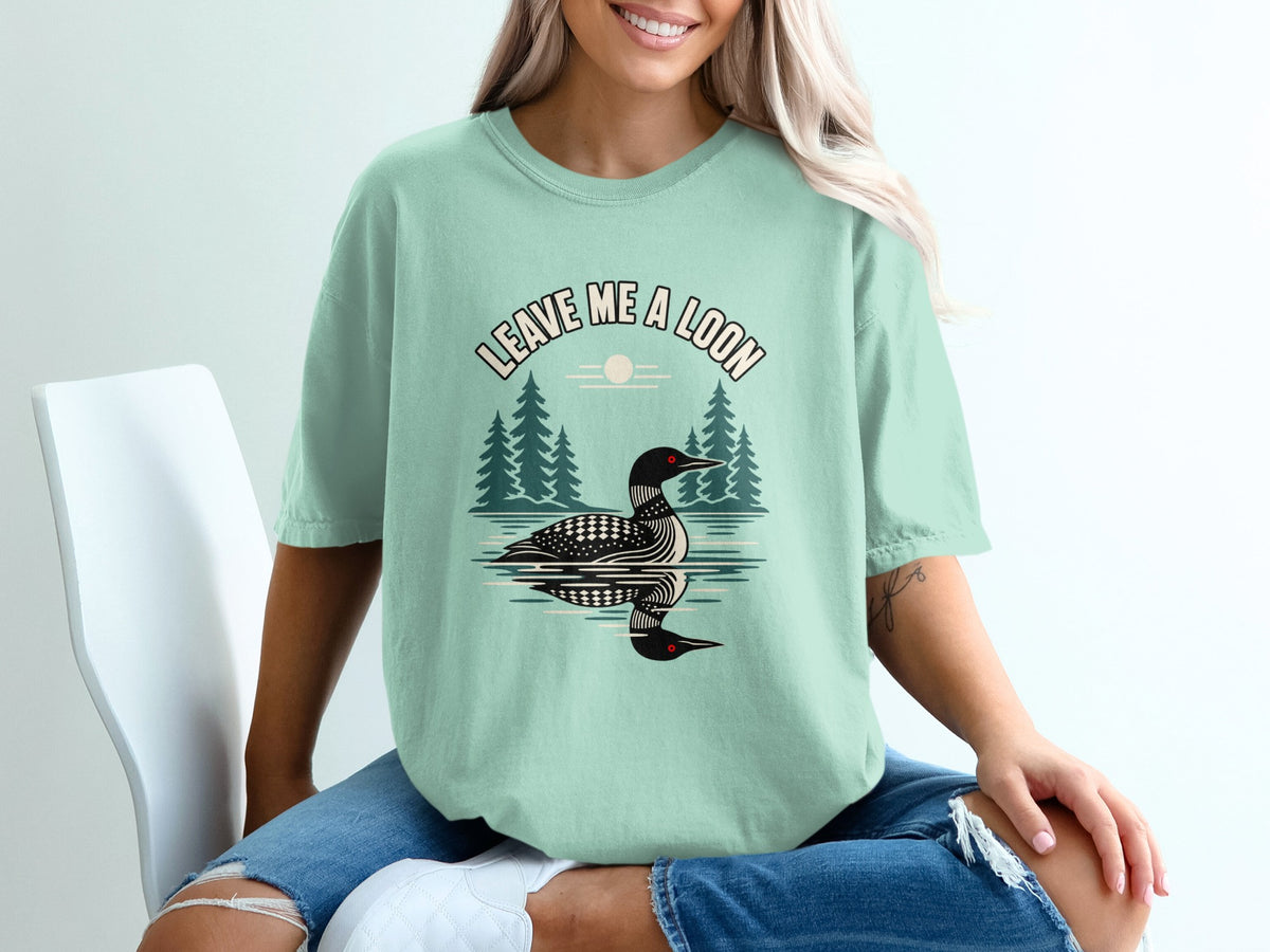T-shirt with graphic of a loon and text "LEAVE ME A LOON".