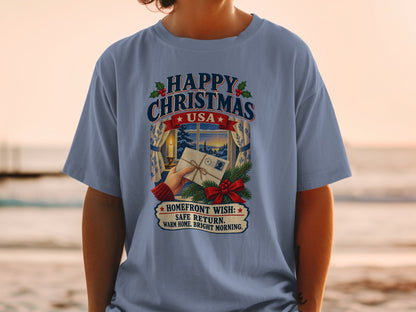 T-shirt with Christmas design reading "Happy Christmas USA Homefront Wish: Safe Return. Warm Home. Bright Morning."