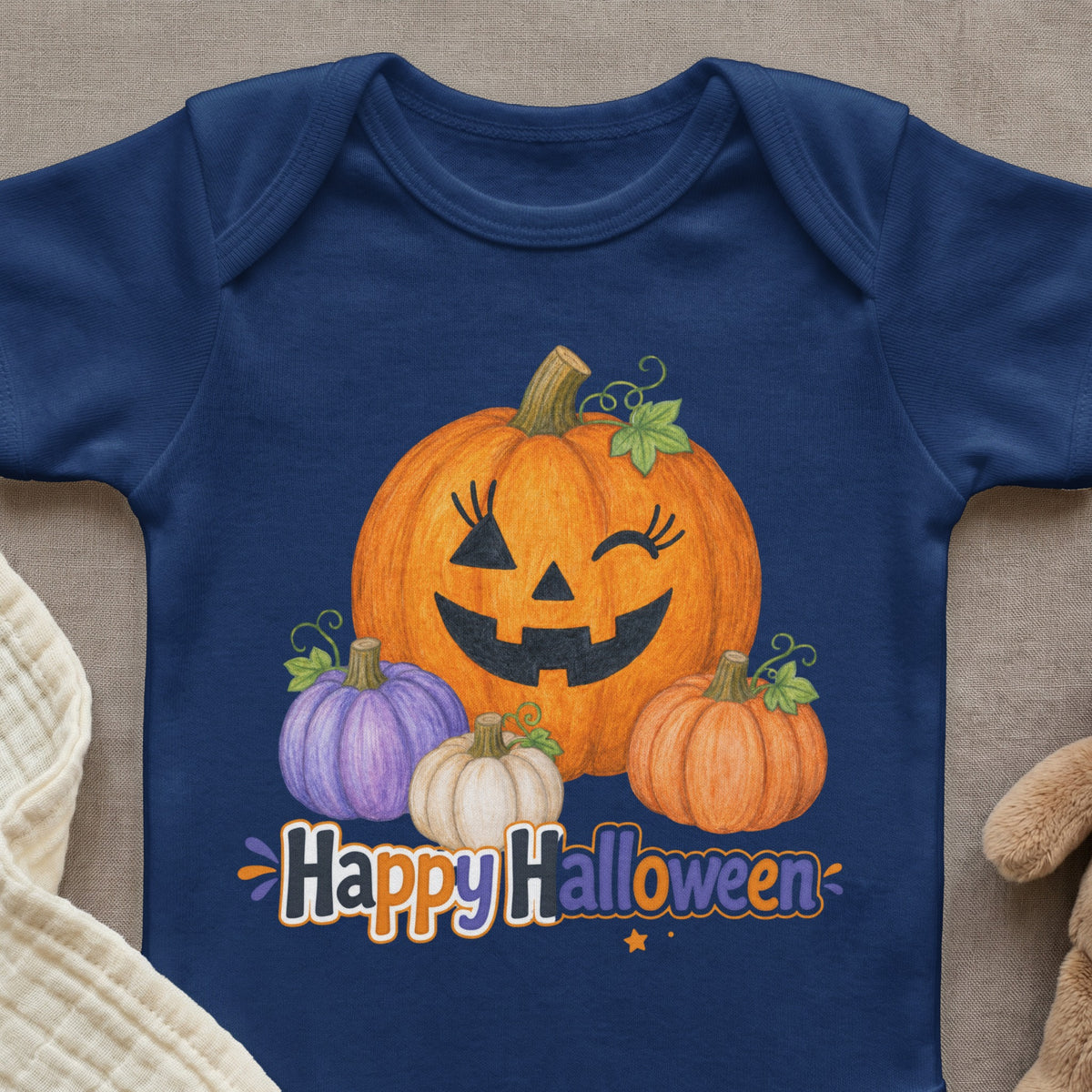 Dark blue baby bodysuit with cartoon pumpkins and text "Happy Halloween".