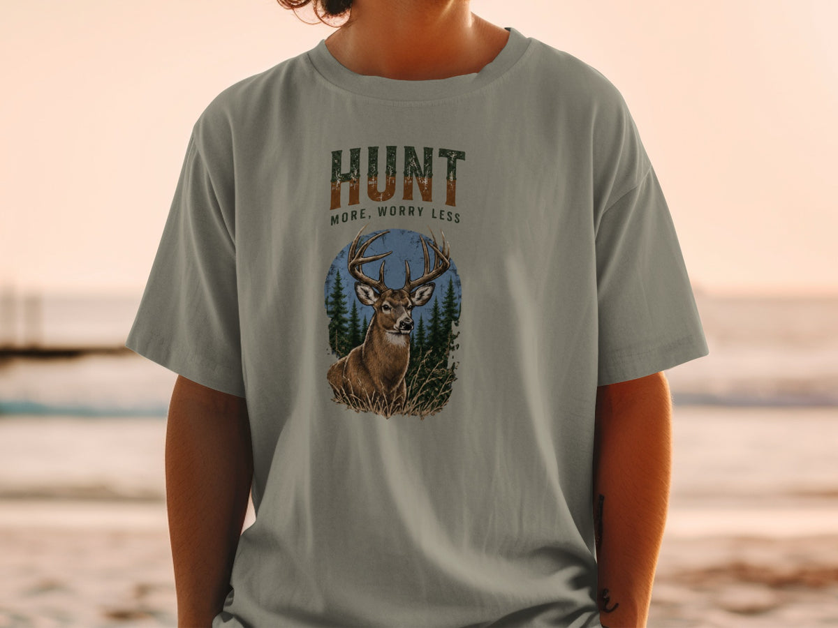 T-shirt graphic with deer, trees, and text "HUNT MORE, WORRY LESS".