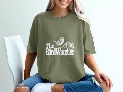 Olive green t-shirt with "The BirdWatcher" text, bird, and binoculars graphic.