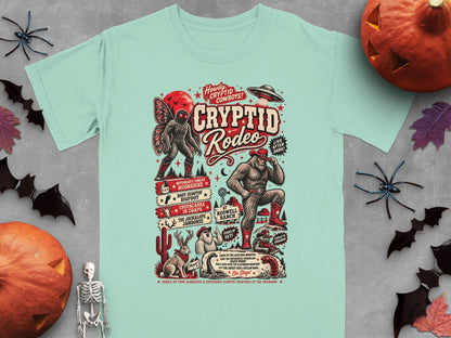 Cryptid Rodeo t-shirt design featuring Mothman, Bigfoot, and other creatures with cowboy themes.