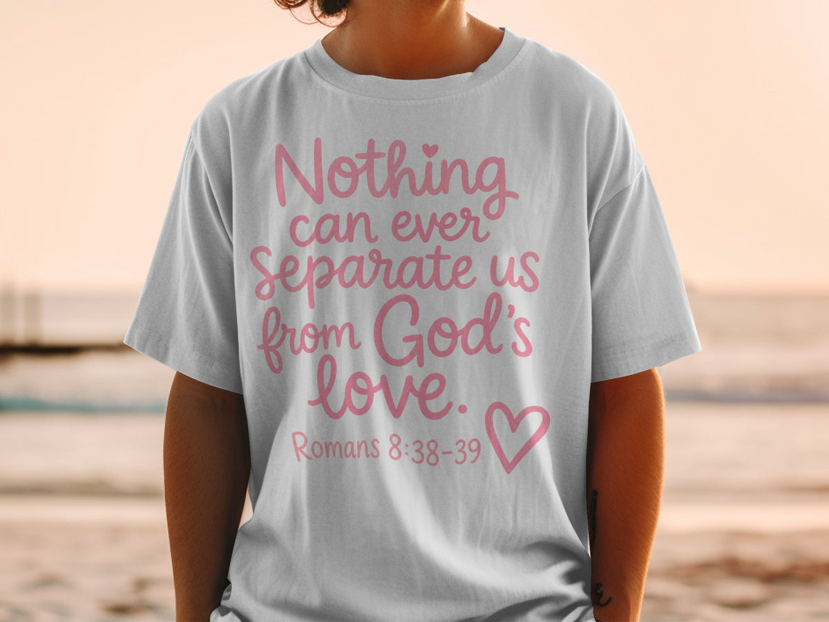 White t-shirt with pink text "Nothing can ever separate us from God's love. Romans 8:38-39".