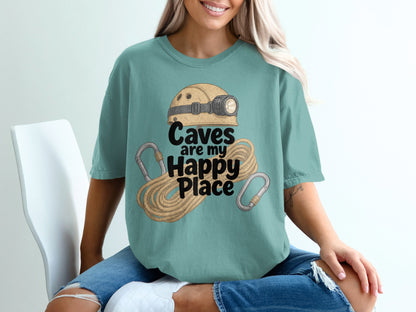 T-shirt graphic: "Caves are my Happy Place" with helmet, rope, and carabiners.