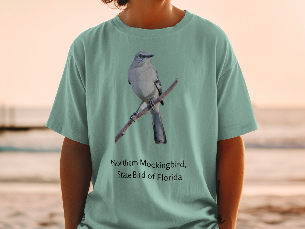 Northern Mockingbird, State Bird of Florida graphic on a teal t-shirt.