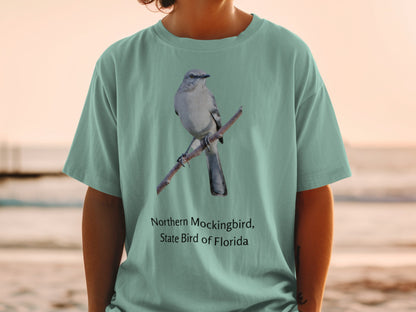 Northern Mockingbird, State Bird of Florida graphic on a teal t-shirt.