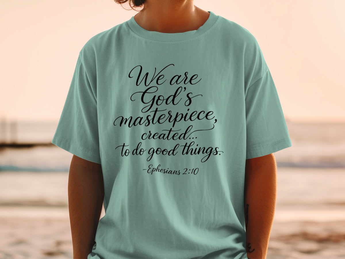 Teal t-shirt with black text "We are God's masterpiece, created... to do good things. -Ephesians 2:10".