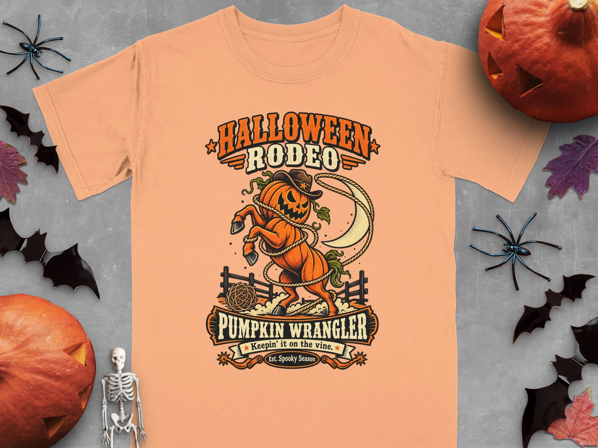Orange t-shirt with Halloween Rodeo Pumpkin Wrangler graphic.