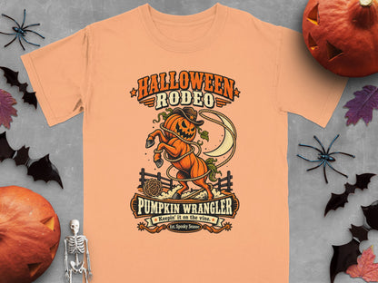Orange t-shirt with Halloween Rodeo Pumpkin Wrangler graphic.