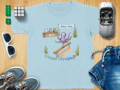 Light blue t-shirt with octopus, seals, and text "Ocean Olympics".