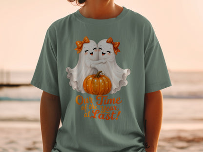 Two ghosts hugging by a pumpkin with text "Our Time of the Year, at Last!"