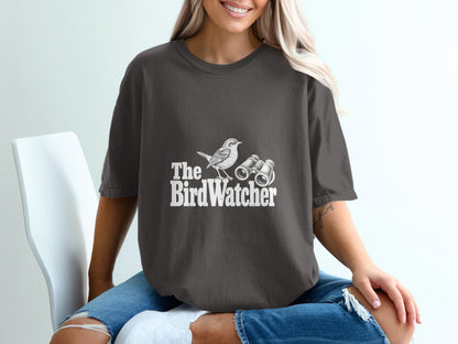 Dark grey t-shirt with white "The Bird Watcher" text and bird graphic.