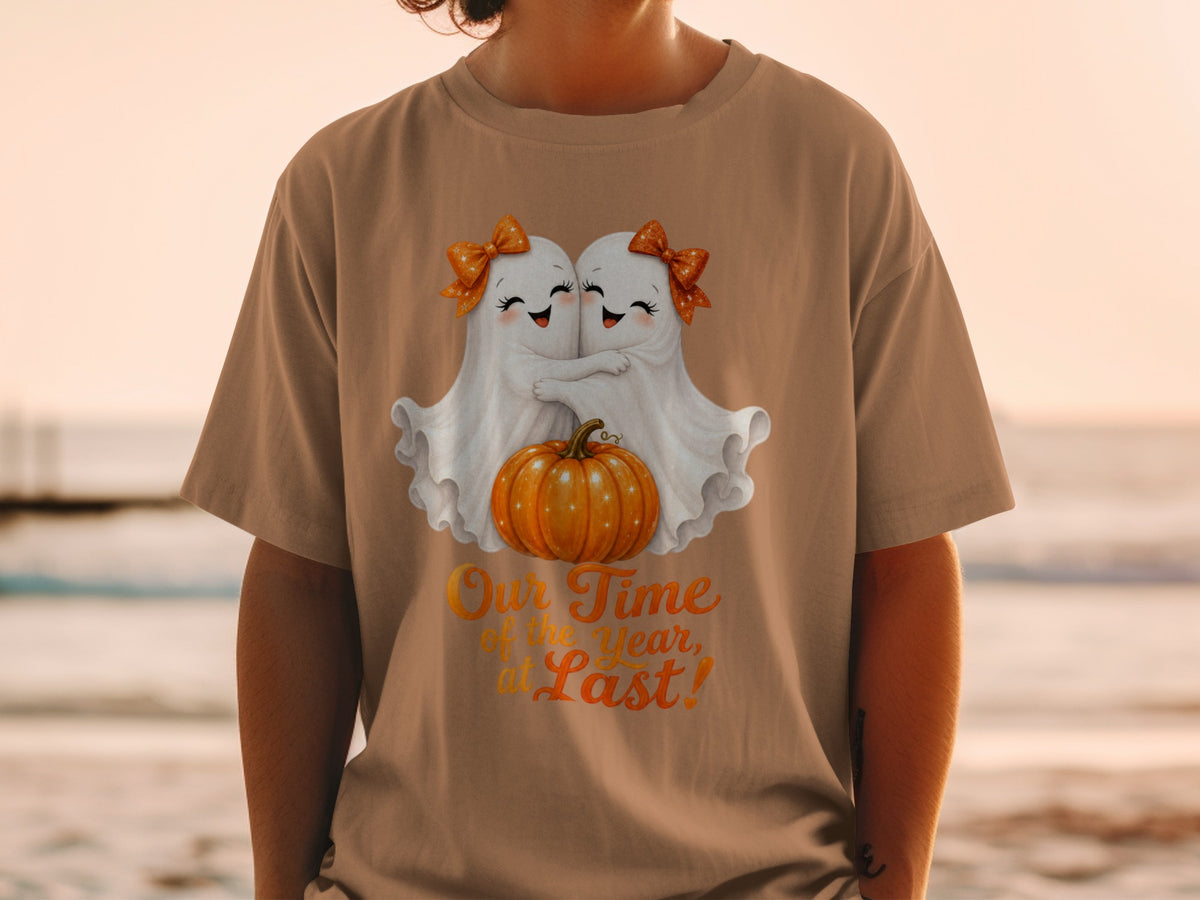 Two ghosts hugging a pumpkin with text "Our Time of the year, at Last!"