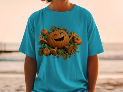 Teal t-shirt with a cartoon jack-o'-lantern and small pumpkins surrounded by leaves.