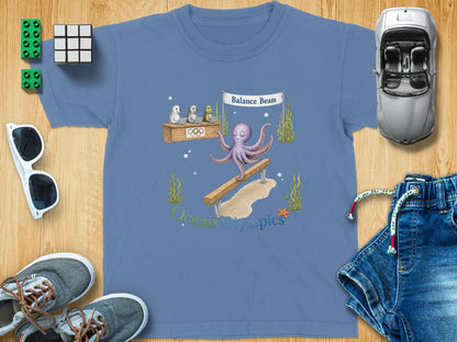 T-shirt graphic: octopus on balance beam, seals and turtle judges, "Ocean Olympics" text.