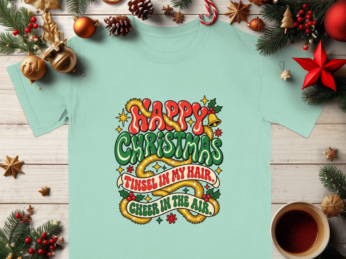 Light blue t-shirt with "Happy Christmas Tinsel in my hair. Cheer in the air." graphic.