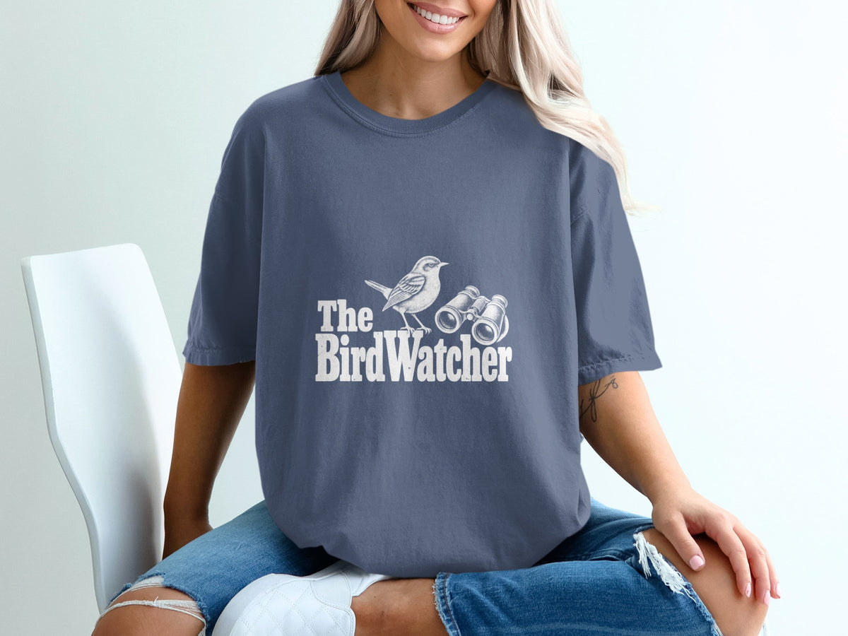 T-shirt with white text and illustration of bird and binoculars.