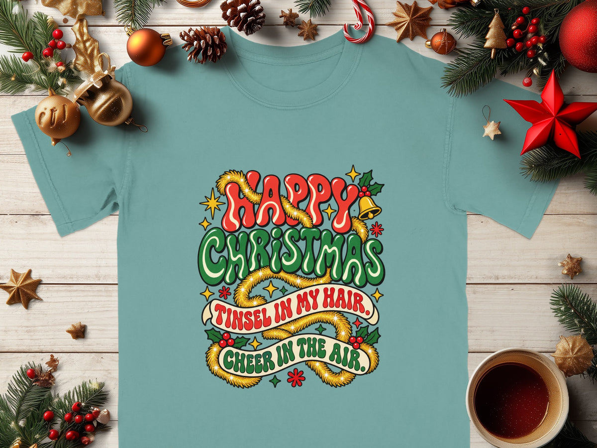 Teal t-shirt with "Happy Christmas, Tinsel in my hair, Cheer in the air" text.
