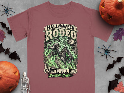Halloween Rodeo Haunted Bull Ride design with green glowing effects on a pink t-shirt.