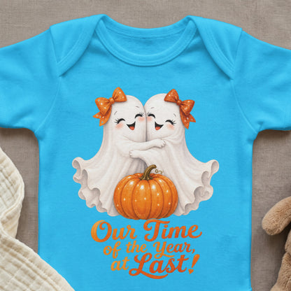 Blue baby bodysuit with two ghosts hugging, pumpkin, and "Our Time of the Year, at Last!" text.