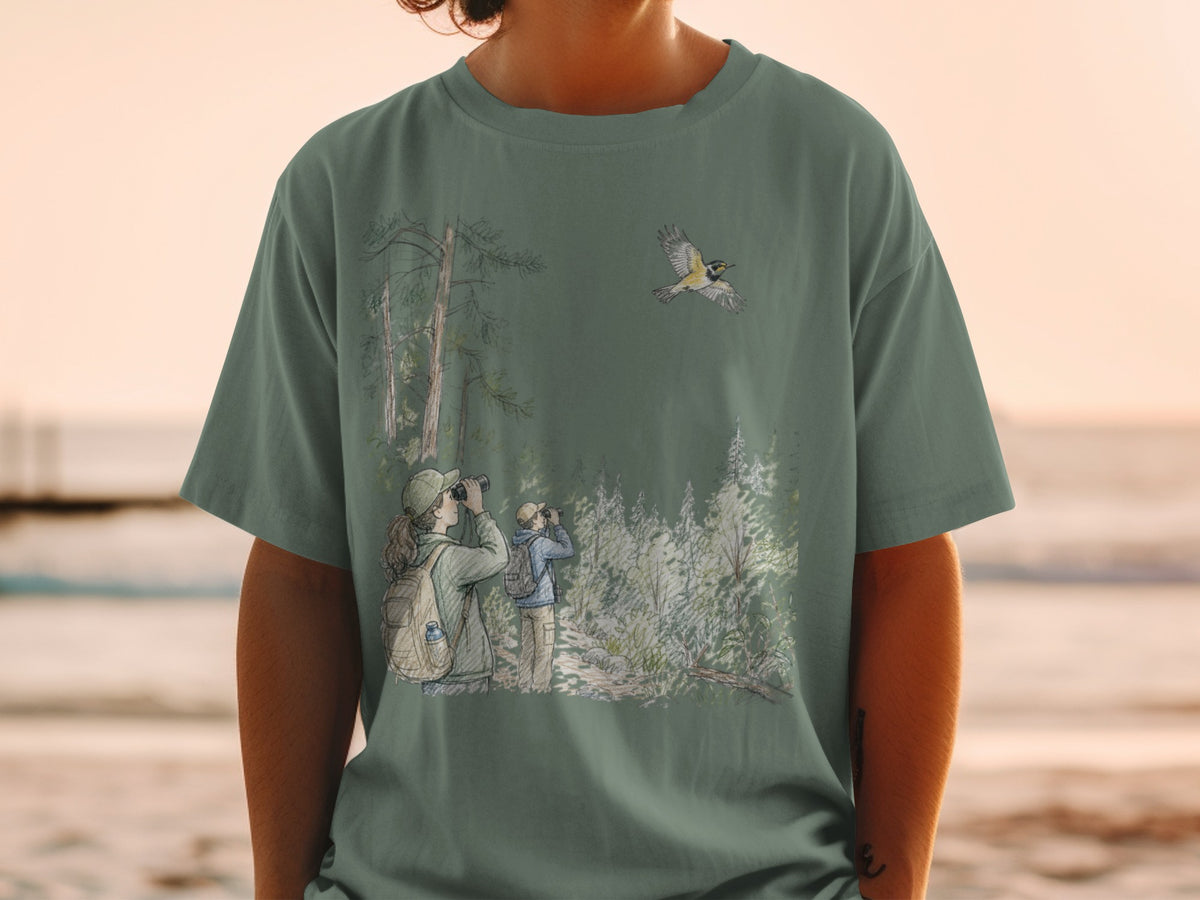 T-shirt graphic with birdwatchers in forest and a bird in flight.