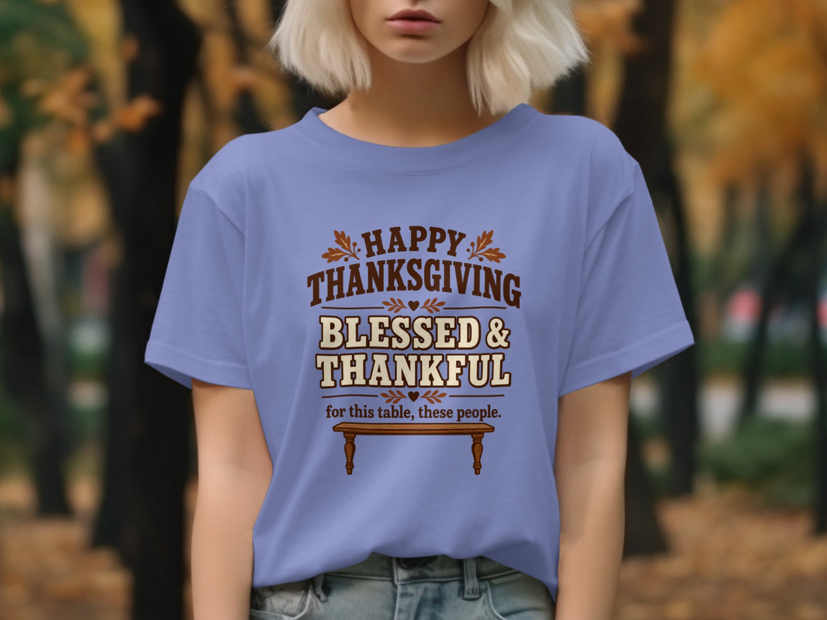 Purple t-shirt with "Happy Thanksgiving Blessed & Thankful" text and a wooden table.