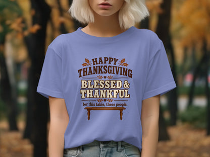 Purple t-shirt with "Happy Thanksgiving Blessed & Thankful" text and a wooden table.