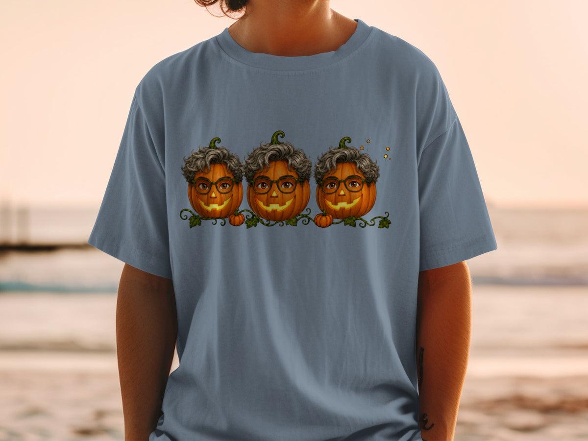Three carved pumpkins with curly hair and glasses sit on a vine.