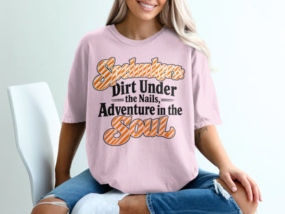 Pink t-shirt with orange and white striped text: "Spelunkers Dirt Under the Nails, Adventure in the Soul".