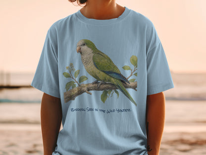 Light blue t-shirt with green parrot illustration and text "BIRDDERS: SEEN IN THE WILD YONDER".