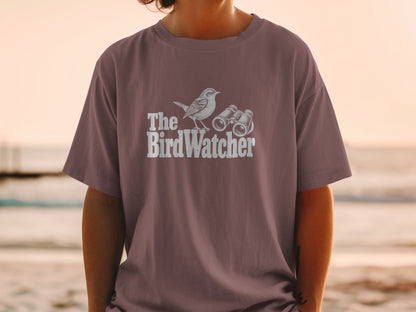 Brown t-shirt with white graphic of a bird and binoculars, reading "The Bird Watcher".