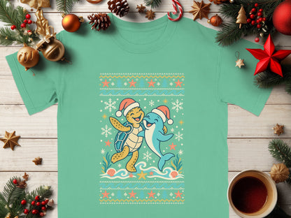 Green t-shirt with a cartoon turtle and dolphin wearing Santa hats.