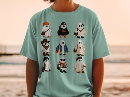 Nine illustrated ghosts wearing trendy outfits and accessories on a light green t-shirt.