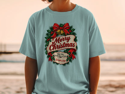 Light blue t-shirt with Merry Christmas wreath, bells, and text.