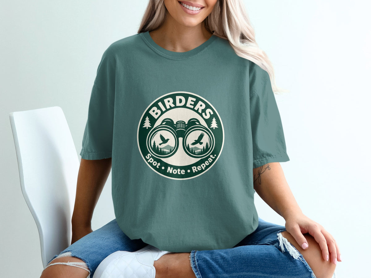 Green t-shirt with "Birders Spot • Note • Repeat." text and binoculars graphic.