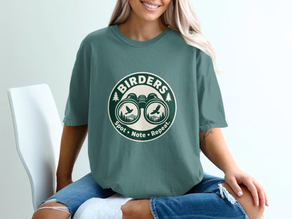 Green t-shirt with "Birders Spot • Note • Repeat." text and binoculars graphic.