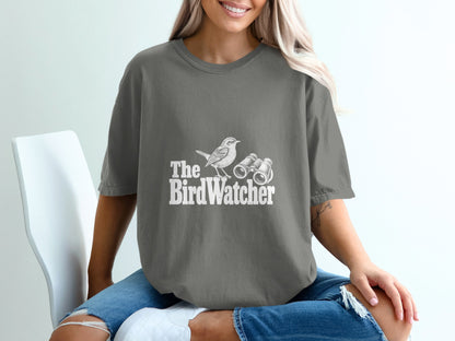 Grey t-shirt with white text and illustration of a bird and binoculars.
