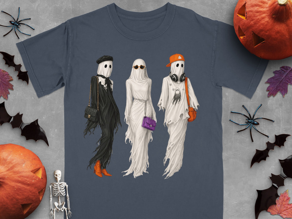 Three ghosts in trendy outfits, on a t-shirt design with Halloween decorations.