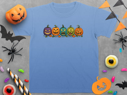 Light blue t-shirt with five cartoon jack-o'-lanterns and small pumpkins.