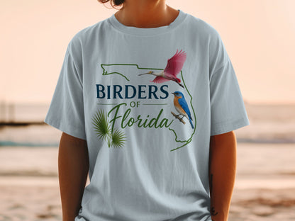 Light blue t-shirt with "Birders of Florida" text and bird illustrations within Florida outline.