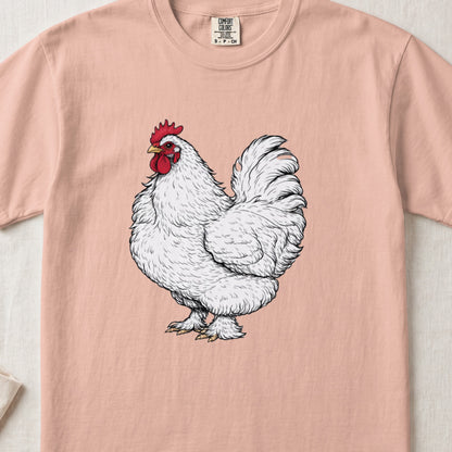 A peach-colored t-shirt featuring a detailed illustration of a white rooster centered on the chest.