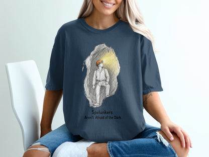 T-shirt with sketch of a spelunker in a cave and text "Spelunkers Aren't Afraid of the Dark".