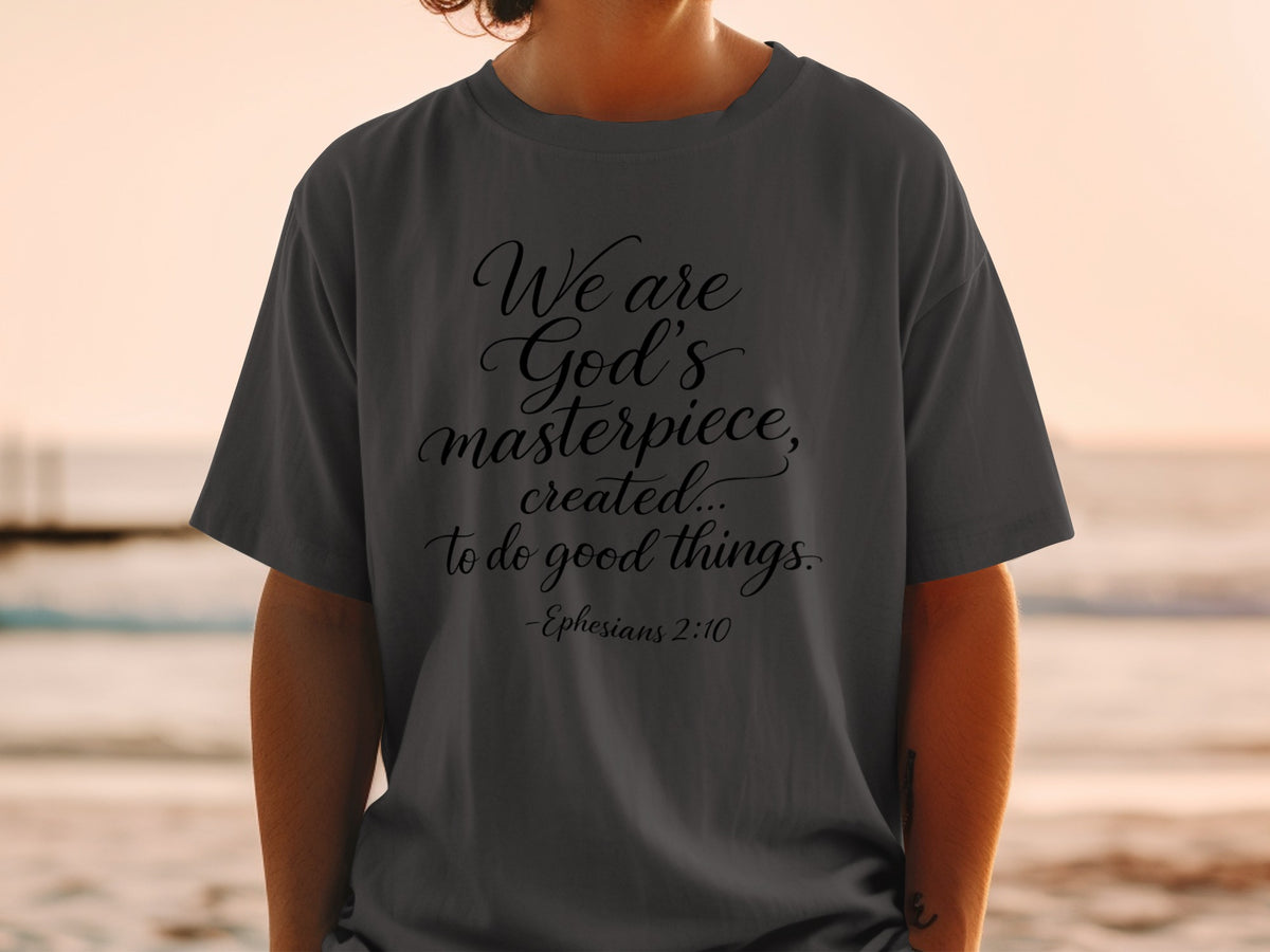Dark grey t-shirt with "We are God's masterpiece, created... to do good things. -Ephesians 2:10"
