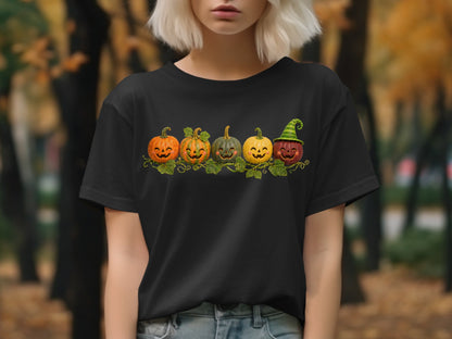 Black t-shirt with five smiling jack-o'-lanterns wearing a striped green hat.