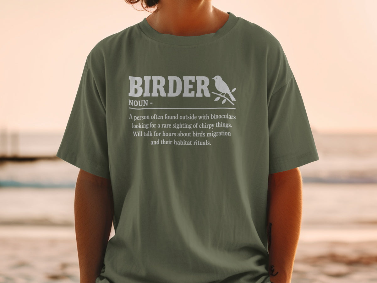 Olive green t-shirt with white text defining "BIRDER" and a small bird graphic.