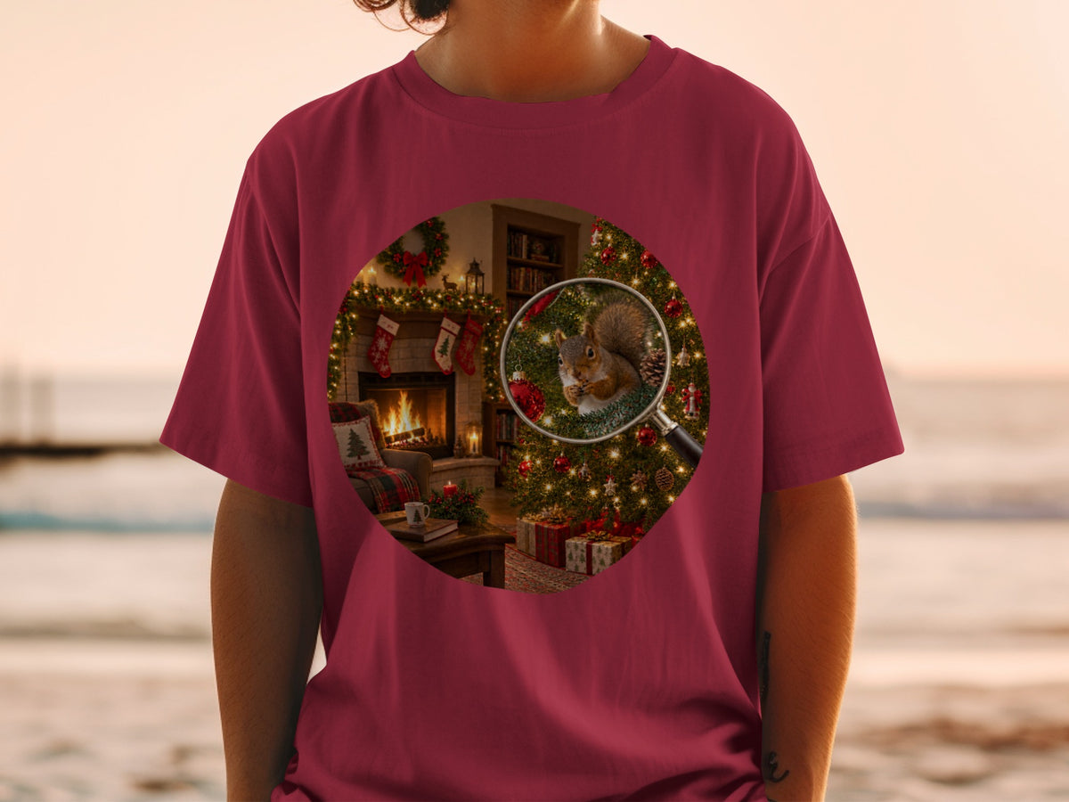 Magnifying glass on squirrel by Christmas tree and fireplace on maroon t-shirt.
