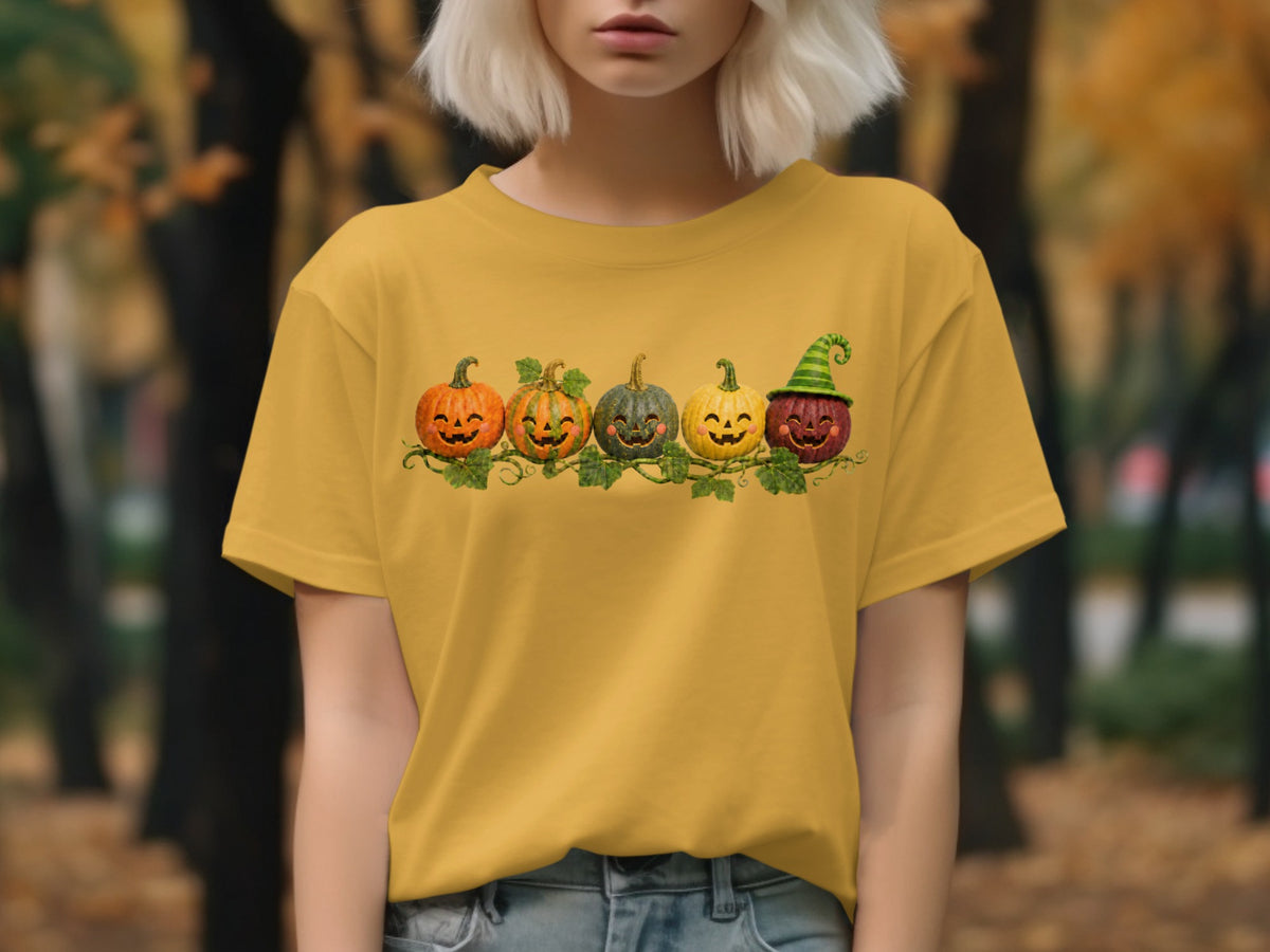 Yellow t-shirt with a row of five smiling jack-o'-lanterns and green vines.