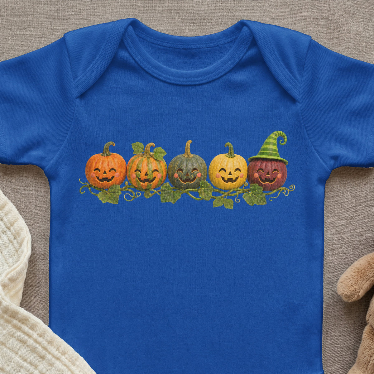 Blue baby bodysuit with a row of smiling carved pumpkins wearing a witch hat.