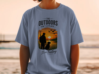 T-shirt graphic: "The Outdoors Isn't a Place... It's a Feeling" with hunter and dog scene.